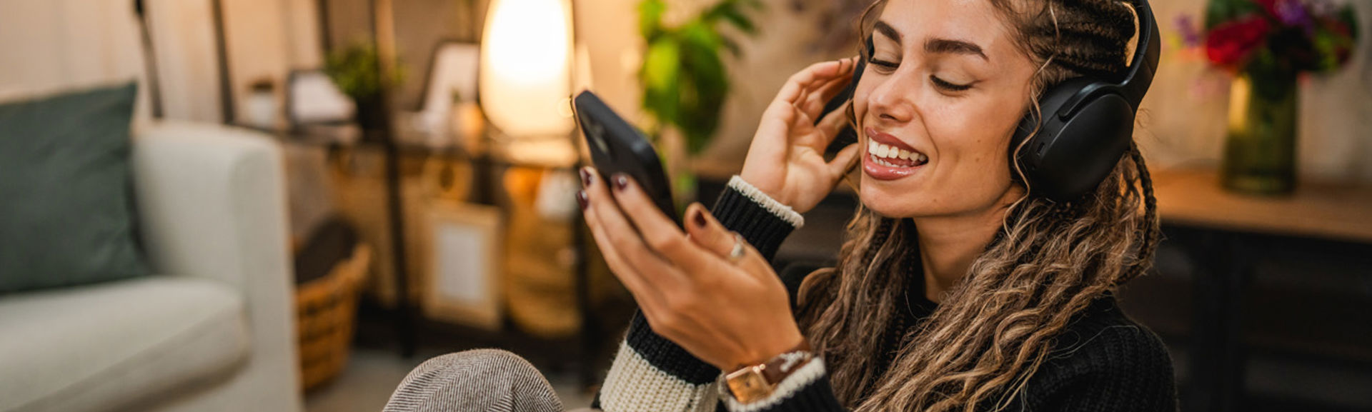 young woman with headphones on mobile_web